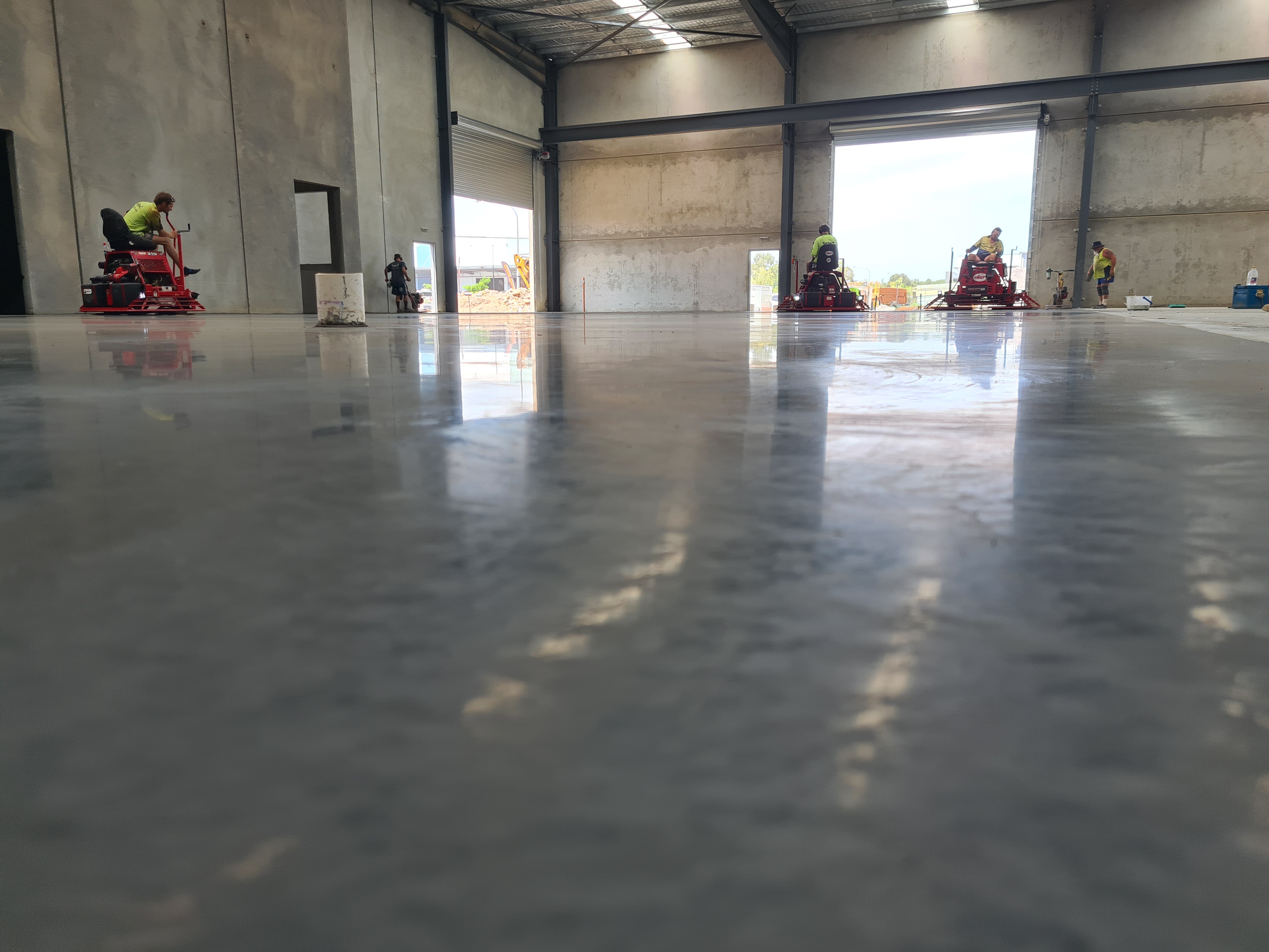 QTM Enterprises warehouse — power trowelling