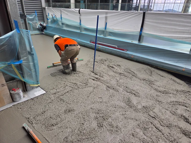 Queen St — concrete finishing on 14th story roof slab